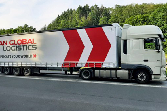 scan-global-logistics-truck-forest-road