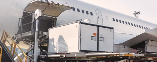 Specialized cargo container being loaded into an aircraft for secure air freight transport.