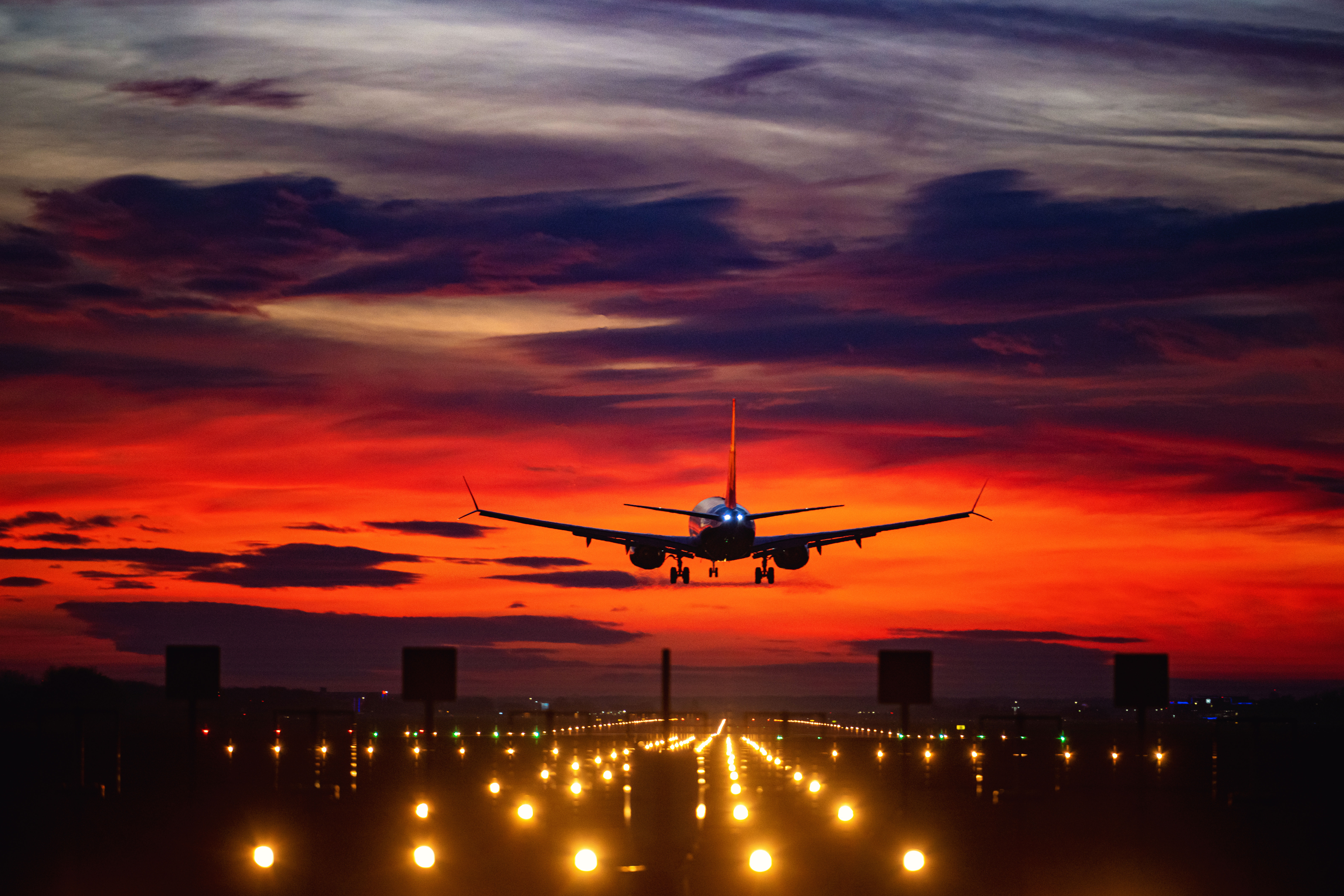 airplane-landing-sunset-runway